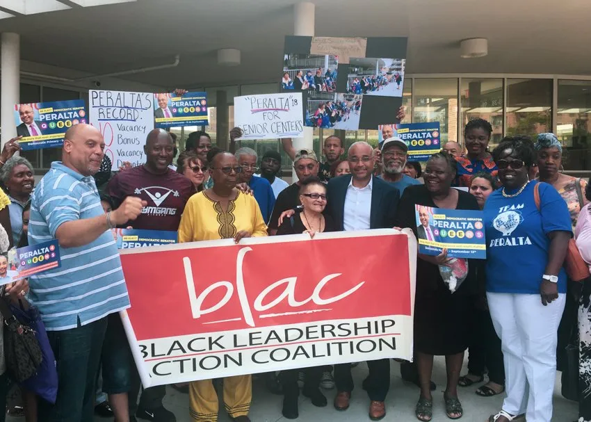 People holding a BLAC sign and gathering in protest